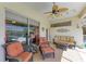 Covered patio area boasts comfortable wicker furniture, a ceiling fan, and sliding glass doors to the interior at 8315 Eagle Xing, Sarasota, FL 34241