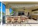Relaxing outdoor patio features bar seating, outdoor kitchen, comfortable seating, and view of the pond at 8315 Eagle Xing, Sarasota, FL 34241