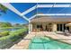 Inviting screened lanai featuring a refreshing pool and relaxing views of the lake at 8315 Eagle Xing, Sarasota, FL 34241