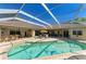 Aerial view of the pool area and patio with outdoor kitchen and comfortable seating at 8315 Eagle Xing, Sarasota, FL 34241