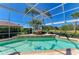 A relaxing pool and hot tub are surrounded by lush landscaping and a screened enclosure at 8315 Eagle Xing, Sarasota, FL 34241