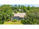 Aerial view of the home with a screened-in pool, lush landscaping, and neighborhood surroundings at 891 Faulkwood Ct, Sarasota, FL 34232