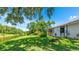 Lush backyard with waterfront views and a screened-in lanai, perfect for outdoor enjoyment at 891 Faulkwood Ct, Sarasota, FL 34232