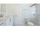 Bathroom features vanity with granite counters, white cabinets, toilet, and tiled shower with glass door at 891 Faulkwood Ct, Sarasota, FL 34232
