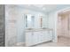 Bathroom features double sink vanity, large mirror, and tiled walk-in shower with glass doors at 891 Faulkwood Ct, Sarasota, FL 34232