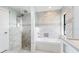 Bathroom features marble tile, built-in tub and shower, and glass shower doors at 891 Faulkwood Ct, Sarasota, FL 34232