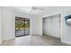 Bedroom features wood flooring, closet, ceiling fan, sliding doors to the pool, and a television at 891 Faulkwood Ct, Sarasota, FL 34232