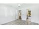 Bright bedroom features wood flooring, white walls, and open doorways at 891 Faulkwood Ct, Sarasota, FL 34232