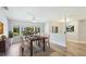 Bright dining room with large windows, wood-style floors, and contemporary decor at 891 Faulkwood Ct, Sarasota, FL 34232