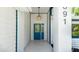 Welcoming front porch featuring a blue door and stylish pendant lighting at 891 Faulkwood Ct, Sarasota, FL 34232