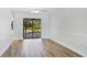 Bright, open living room featuring wood-style floors, contemporary ceiling fan, and natural light at 891 Faulkwood Ct, Sarasota, FL 34232