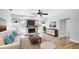 Comfortable living room with a fireplace, ceiling fan, and hardwood floors at 891 Faulkwood Ct, Sarasota, FL 34232