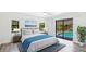 Main bedroom with a king bed and view of a screened-in pool area at 891 Faulkwood Ct, Sarasota, FL 34232
