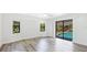 Spacious main bedroom with natural light and a view of the screened-in pool area at 891 Faulkwood Ct, Sarasota, FL 34232