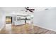 Open concept living space showcasing a kitchen and living area with hardwood floors at 891 Faulkwood Ct, Sarasota, FL 34232