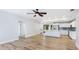 Open concept living space with a kitchen and living area featuring hardwood floors at 891 Faulkwood Ct, Sarasota, FL 34232
