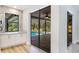 View of the pool through sliding glass doors from a room with white cabinets at 891 Faulkwood Ct, Sarasota, FL 34232