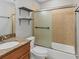 Bathroom featuring a single sink vanity, toilet, and shower/tub combo with sliding glass door at 924 La Costa Cir # 4, Sarasota, FL 34237