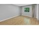 Bedroom features wood-look flooring, neutral paint, and a large window with curtains for natural light at 924 La Costa Cir # 4, Sarasota, FL 34237