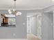 The dining area features a pass-through window to the kitchen and views of a large entry hallway at 924 La Costa Cir # 4, Sarasota, FL 34237