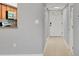Entryway with tile flooring, a white front door, and a view into the kitchen through a cut-out at 924 La Costa Cir # 4, Sarasota, FL 34237