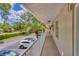 Exterior walkway featuring white railings, view of the parking area, and well-maintained landscaping at 924 La Costa Cir # 4, Sarasota, FL 34237