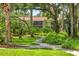 Picturesque pathway winding through mature landscaping with trees and greenery in a peaceful setting at 924 La Costa Cir # 4, Sarasota, FL 34237