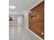 Living room showcasing modern lighting, neutral paint, tile floors, and a wood accent wall at 924 La Costa Cir # 4, Sarasota, FL 34237