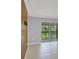 Living room with tile flooring and sliding glass doors to the screened-in balcony at 924 La Costa Cir # 4, Sarasota, FL 34237