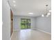 Bright living room with tile floors, a sliding glass door to a screened balcony, and contemporary lighting at 924 La Costa Cir # 4, Sarasota, FL 34237