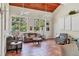 Bright living room with tile floors, high ceilings with fans, and large windows showcasing the tropical landscaping at 924 La Costa Cir # 4, Sarasota, FL 34237