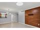 Bright living room featuring tile flooring, modern light fixture, and open access to the kitchen at 924 La Costa Cir # 4, Sarasota, FL 34237