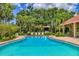 Inviting community pool surrounded by lush landscaping and comfortable lounge chairs, perfect for relaxation at 924 La Costa Cir # 4, Sarasota, FL 34237