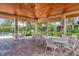 Covered poolside patio area featuring tables and chairs for residents to relax and socialize by the community pool at 924 La Costa Cir # 4, Sarasota, FL 34237