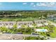 Aerial view showcases a well-maintained community, pool, lush greenery, golf course, and a tranquil lake at 9580 High Gate Dr # 1822, Sarasota, FL 34238