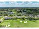 Aerial shot of a community with mature landscaping, golf course, tennis courts, lakes and swimming pool at 9580 High Gate Dr # 1822, Sarasota, FL 34238