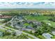 The aerial view features a clubhouse, golf course, tennis courts, community pool and lush surroundings at 9580 High Gate Dr # 1822, Sarasota, FL 34238