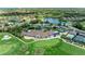 Aerial image highlights a clubhouse, tennis courts, golf course, a pool and beautifully landscaped grounds at 9580 High Gate Dr # 1822, Sarasota, FL 34238