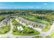 Aerial view features a community, pool, lush landscaping, a golf course, and a peaceful lake at 9580 High Gate Dr # 1822, Sarasota, FL 34238