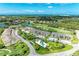 Panoramic aerial view of a community with residential buildings, golf course, ponds, and lush greenery at 9580 High Gate Dr # 1822, Sarasota, FL 34238