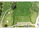 Overhead view of a pristine golf course with lush greens, manicured landscaping, and challenging sand traps at 9580 High Gate Dr # 1822, Sarasota, FL 34238