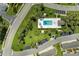 Overhead view of a community pool area with a pool, lounge chairs, and well-maintained landscaping at 9580 High Gate Dr # 1822, Sarasota, FL 34238