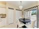 View of the dining room with a black table and white chairs at 9580 High Gate Dr # 1822, Sarasota, FL 34238