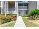 Inviting condo exterior with manicured landscaping and screened-in lanai at 9580 High Gate Dr # 1822, Sarasota, FL 34238