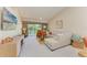Bright living room with vaulted ceilings, fan and view from screened in lanai at 9580 High Gate Dr # 1822, Sarasota, FL 34238