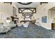 Elegant clubhouse lobby with a fireplace, comfortable seating, and a stylish bar area at 9580 High Gate Dr # 1822, Sarasota, FL 34238