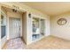 Cozy covered patio featuring tile flooring, chandelier, and sliding glass door at 9580 High Gate Dr # 1822, Sarasota, FL 34238