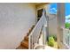 Exterior staircase with tile steps and white railings to the condo's entrance at 9580 High Gate Dr # 1822, Sarasota, FL 34238