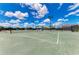 Well-maintained tennis court with a net and benches, perfect for a friendly match or serious practice at 9580 High Gate Dr # 1822, Sarasota, FL 34238