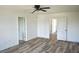Bedroom featuring wood floors and access to multiple rooms at 10019 Geese Trail Cir, Sun City Center, FL 33573